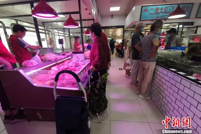 图为北京市西城区一家菜市场,不少人正在买肉。 中新网记者 谢艺观 摄 图为北京市西城区一家菜市场,不少人正在买肉。 中新网记者 谢艺观 摄