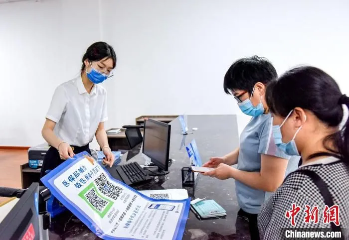民众领取医保点子凭证 吴晓红 摄
