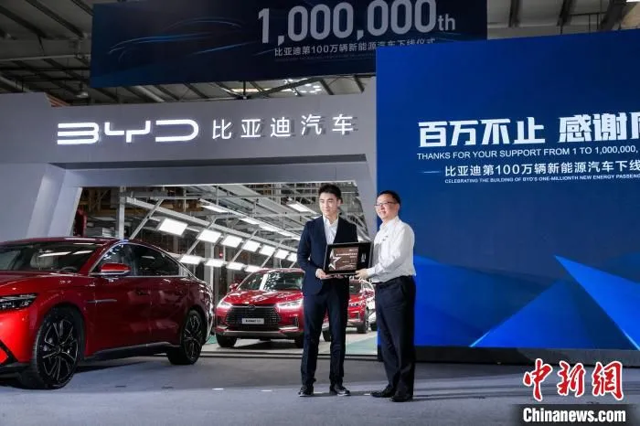深圳V5电子竞技俱乐部董事长兼CEO何猷君(左)成比亚迪新能源汽车的第100万位车主。　比亚迪供图