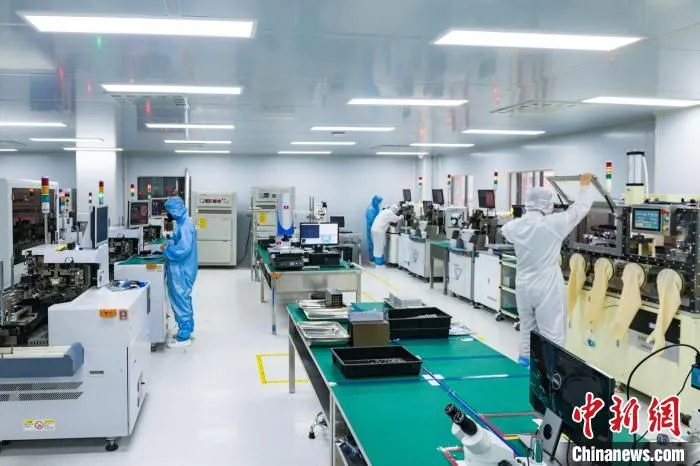 图为重庆联叁盛光电科技有限公司智能化生产车间，工作人员在设备上作业。　邹乐 摄