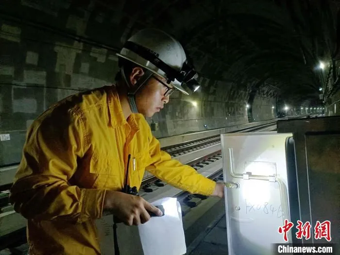 图为工人在检查送电线路设备。　鞠磊 摄