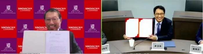 长段崇智(左)与科兴控股董事长、总裁兼CEO尹卫东(右)(企业供图)
