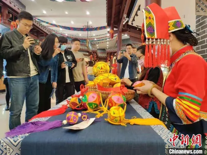 壮族姑娘正在制作民族手工艺品。　中新网记者 张旭 摄