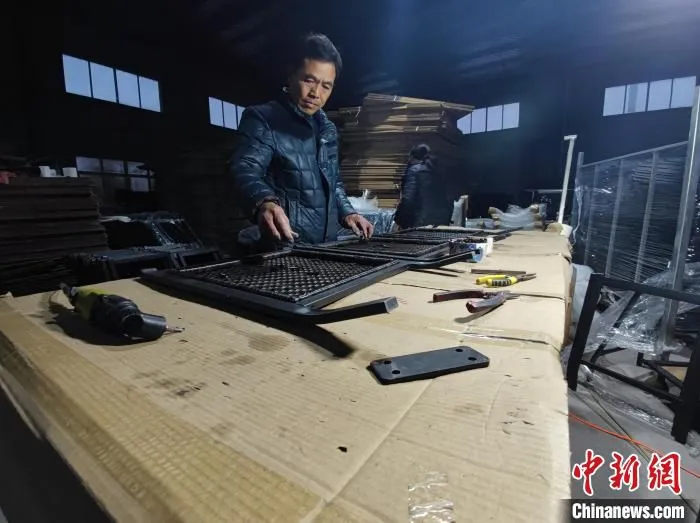 家具厂车间里，工人正在进行家具组装。　阚力 摄