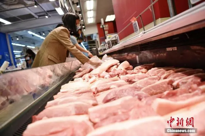 图为成都市民在当地一家超市内挑选猪肉。(资料图片) 中新社记者 张浪 摄