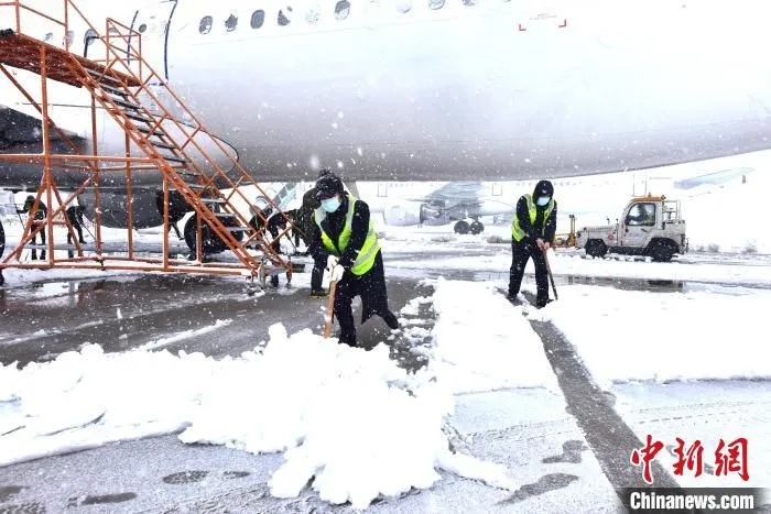 工作人员扫雪除冰。　东航江苏公司供图