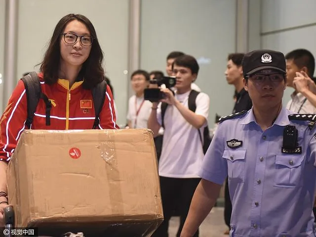 女排载誉回国球迷拉横幅迎接 粉丝现场唱国歌