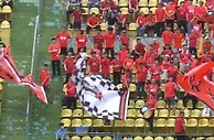 广州队中甲首战越秀山体育场球迷众多，身穿红色球衣摇旗呐喊